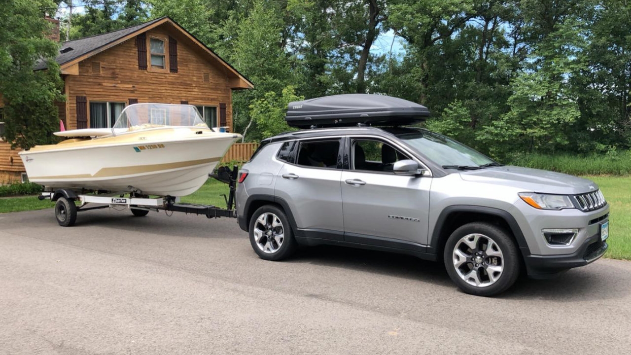 vue latérale avant d'un Jeep Compass 2025 qui remorque un bateau
