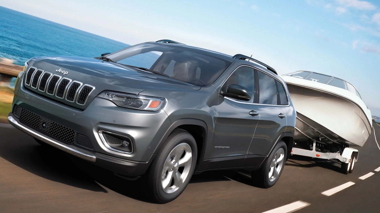vue latérale avant d'un Jeep Cherokee 2025 qui remorque un bateau