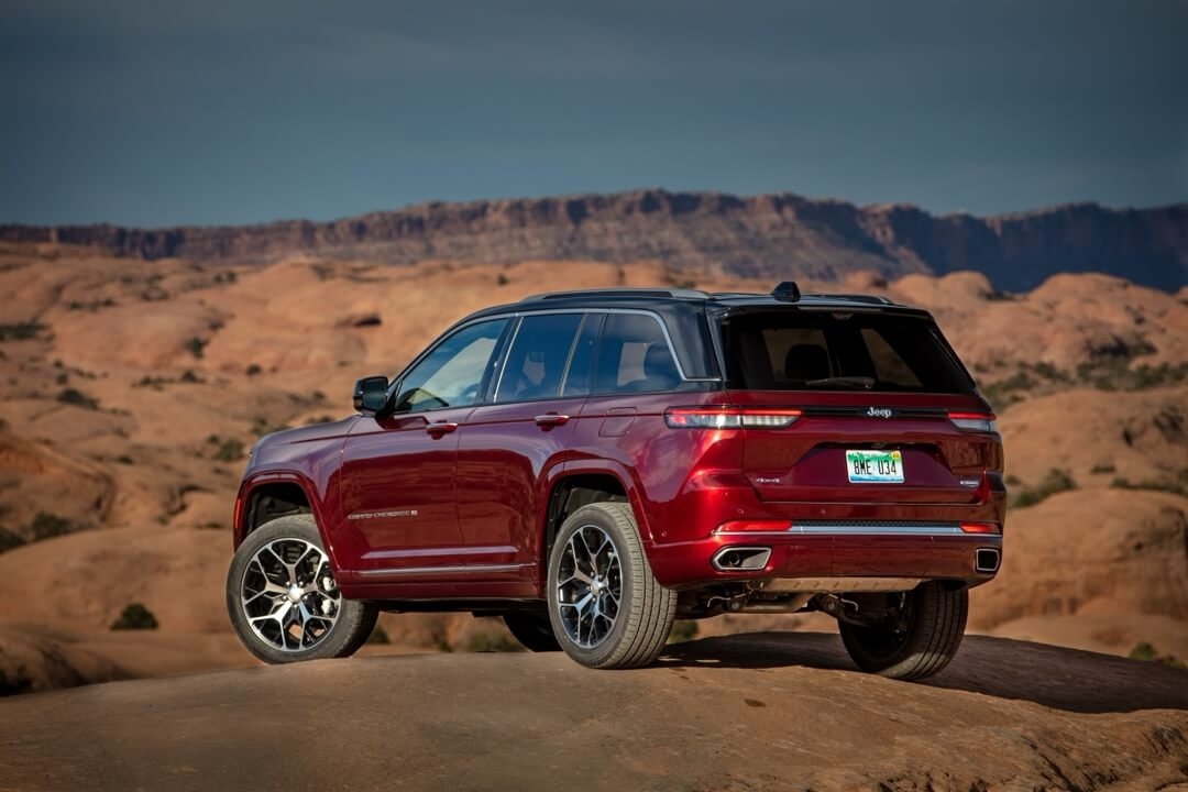 Back 3/4 view of the 2024 Jeep Grand Cherokee parked in a desert.
