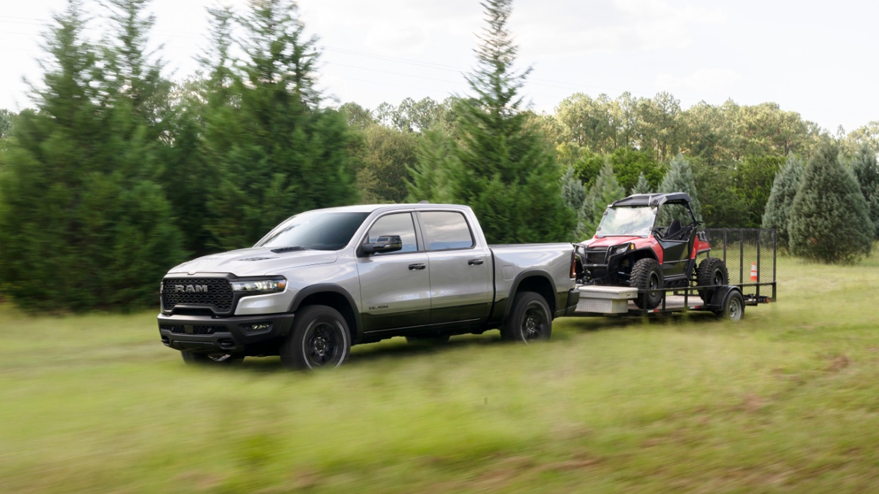 vue latérale avant d'un camion RAM 1500 2025 en train de remorquer un véhicule