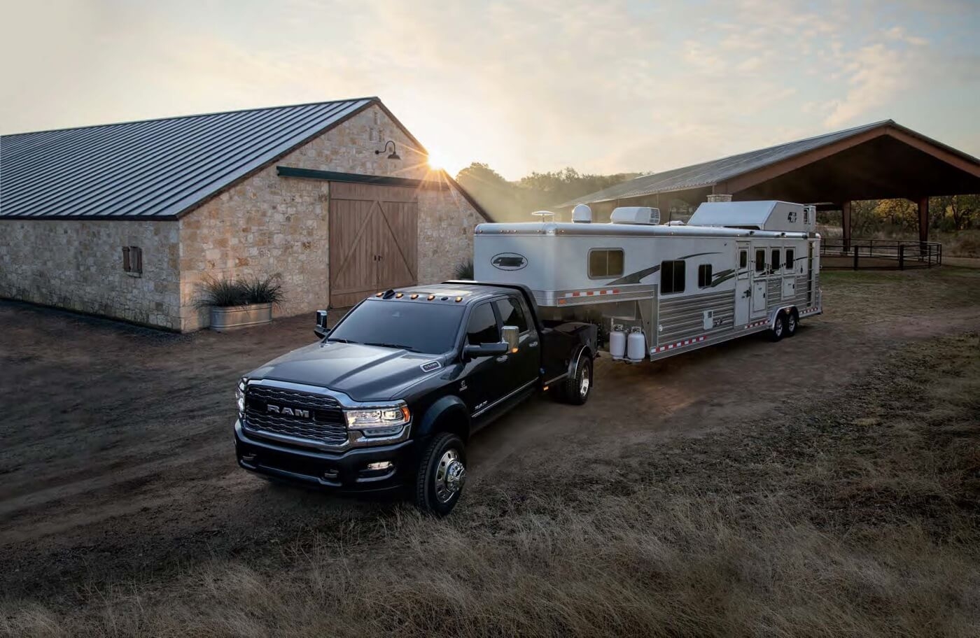 Front 3/4 view of the 2025 Ram Chassis Cab 5500 towing a trailer.